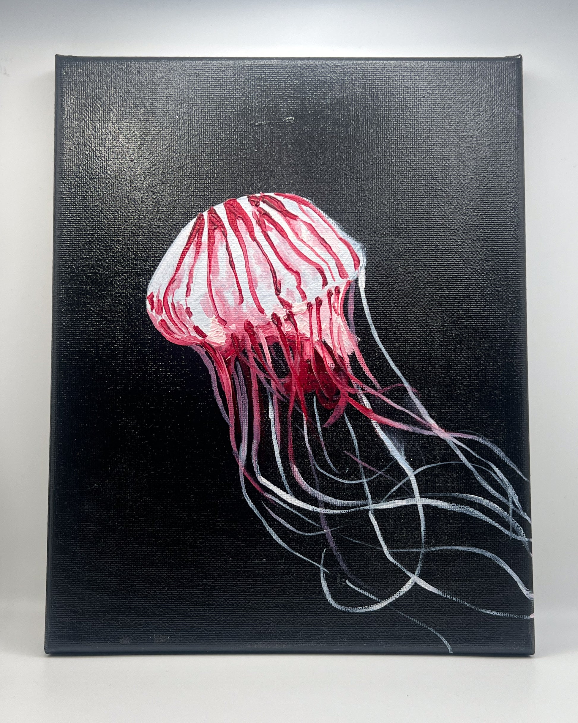Canvas painting of a red jellyfish on a black background